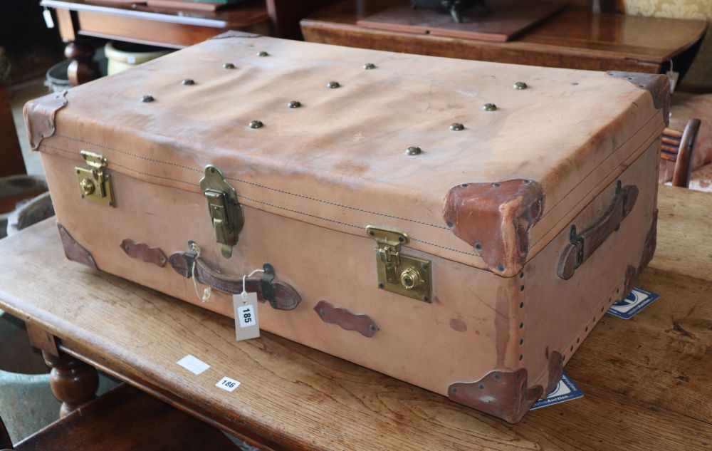 A 1950s studded leather-bound pigskin travelling trunk with brass locks, W.89cm, D.62cm H.32cm